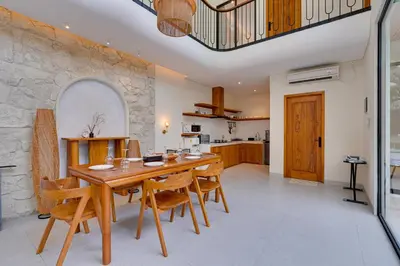 a kitchen and dining room with a wooden table and chairs at Private 3BR Villa Sweetie with Pool Seminyak in Seminyak