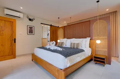 a bedroom with a large bed with white sheets at Private 3BR Villa Sweetie with Pool Seminyak in Seminyak
