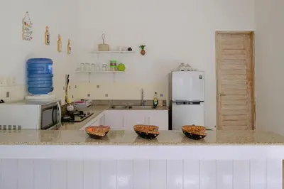 a kitchen with three baskets on a counter with a refrigerator at Villa Beji Ayu Seminyak - 2 Bedroom Private Pool in Seminyak