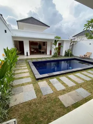 a swimming pool in the yard of a house at Arts Ebena Villa Two-Bedroom Private Pool Kuta in Seminyak