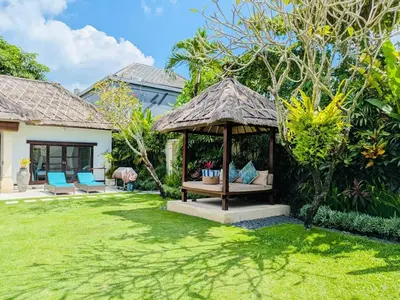 a gazebo with a table and chairs in a yard at Villas Seminyak in Seminyak