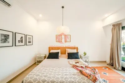 a bedroom with a large bed and a pendant light at Luxury 3BR Umalas Villa Pool & Wi-Fi in Kerobokan
