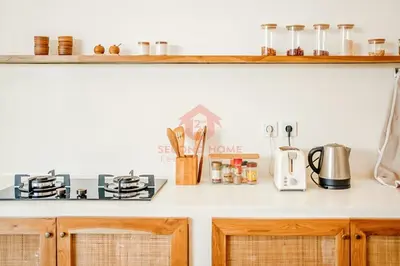 a kitchen with a counter top with a stove at Luxury 3BR Umalas Villa Pool & Wi-Fi in Kerobokan