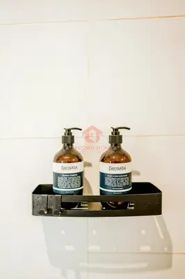 two bottles ofodorizers on a shelf in a bathroom at Luxury 3BR Umalas Villa Pool & Wi-Fi in Kerobokan