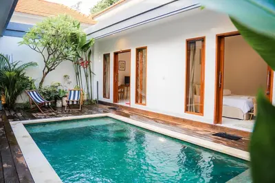 a villa with a pool and a bedroom at Satori Villa Umalas in Canggu