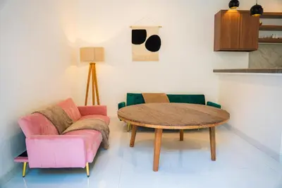 a living room with a table and two chairs at Satori Villa Umalas in Canggu