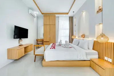 a bedroom with a large bed and a television at Villa Tébu 3 BR Brand New Villa in Umalas in Kerobokan