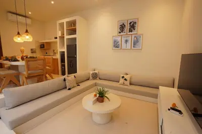 a living room with a couch and a table at 5 min to Finns Beach Club & Trendy Hotspot in Canggu