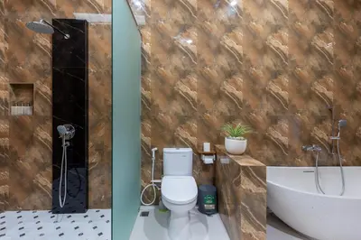 two pictures of a bathroom with a toilet and a sink at Villa Sunshyne in Seminyak