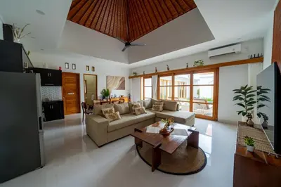 a living room with a couch and a table at Villa Sunshyne in Seminyak