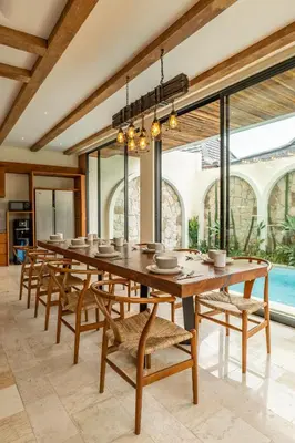 a large dining room with a long table and chairs at Tuluscoliving villa kuta 2, 4 Bedroom & 5 Bathroom in Ngurah Rai International Airport