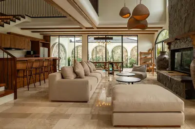 a living room with a couch and a table at Tuluscoliving villa kuta 2, 4 Bedroom & 5 Bathroom in Ngurah Rai International Airport