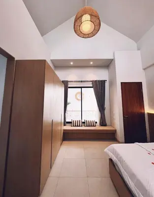a bedroom with a bed and a window at Villa Jasmine in Seminyak