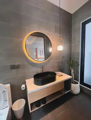 a bathroom with a black sink and a mirror at Villa Jasmine in Seminyak