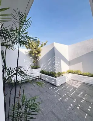 a courtyard with trees and plants in a building at Villa Jasmine in Seminyak