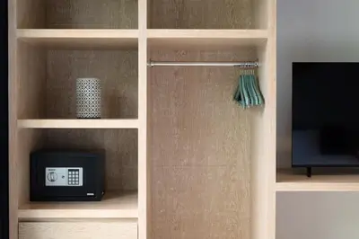 a book shelf with a television and a tv at Villa Orchid Berawa in Canggu