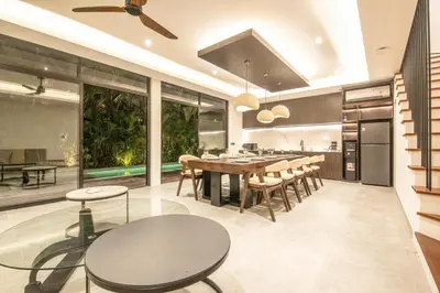 a kitchen and dining room with a table and chairs at Enchanting 5BR Canggu Villa Moments to Sea in Canggu