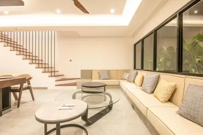 a living room with a couch and a table at Enchanting 5BR Canggu Villa Moments to Sea in Canggu