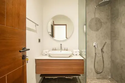 a bathroom with a sink and a shower at Enchanting 5BR Canggu Villa Moments to Sea in Canggu