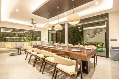 a large dining room with a long table and chairs at Enchanting 5BR Canggu Villa Moments to Sea in Canggu
