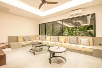 a living room with a couch and two tables at Enchanting 5BR Canggu Villa Moments to Sea in Canggu