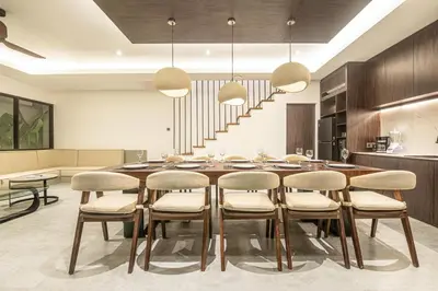 a dining room with a large wooden table and chairs at Coastal Chic 5BR Luxury Villa Canggu Beachside in Canggu
