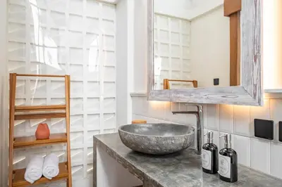 a bathroom with a stone sink and a mirror at 2BR Villa in Canggu, Villa Sejiwa 3 in Canggu