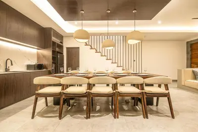 a dining room with a table and chairs at Hidden Paradise 5BR Canggu Gem Near Waves in Canggu