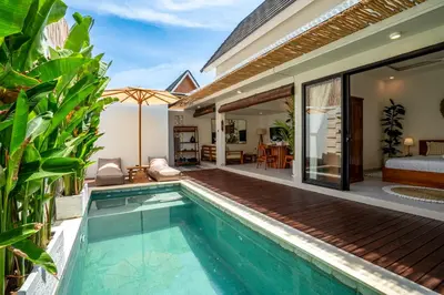 a villa with a swimming pool and a bedroom at Cozy 2BR Villa Nara with Private Pool and Fitness Corner in Seminyak -Bali in Seminyak