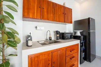 a kitchen with a sink and a refrigerator at Cozy 2BR Villa Nara with Private Pool and Fitness Corner in Seminyak -Bali in Seminyak
