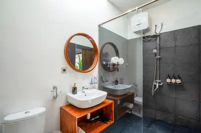 a bathroom with a sink and a shower at Cozy 2BR Villa Nara with Private Pool and Fitness Corner in Seminyak -Bali in Seminyak