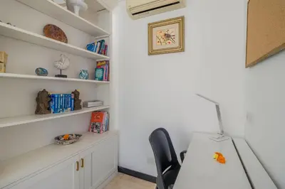 a room with a table and a chair and shelves at Villa Mattina, Umalas in Canggu