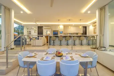 a dining room with a table and chairs and a kitchen at Villa Mattina, Umalas in Canggu