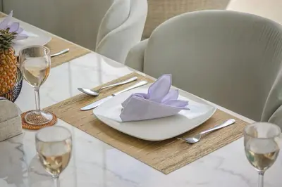 a table with a plate with a purple flower on it at Villa Mattina, Umalas in Canggu