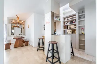 a kitchen with a bar and a dining room at Villa Azure 2 - Private Pool Villa near Seminyak Centre in Seminyak