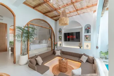a living room with a couch and a bedroom at Villa MAVI Seminyak in Seminyak