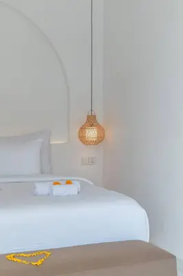 a white bedroom with a bed and a light fixture at Villa MAVI Seminyak in Seminyak