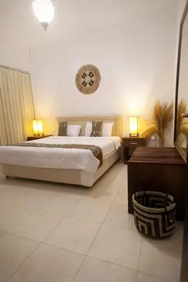 a bedroom with a large bed and a clock on the wall at 3 Bedroom Villa in Prime Seminyak Location, Walk to Beach in Seminyak