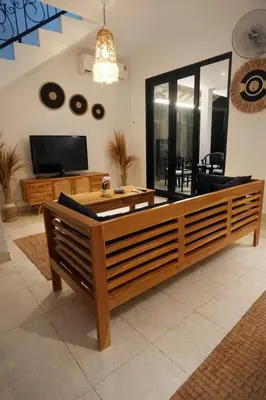 a living room with a coffee table and a tv at 3 Bedroom Villa in Prime Seminyak Location, Walk to Beach in Seminyak