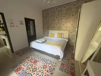 a bedroom with a large bed with a rug at Villa Rumah Lemon Nusa Dua in Nusa Dua