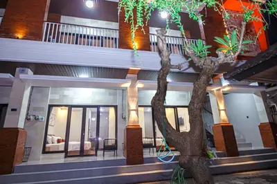 a building with a tree in front of it at The Hunian in Seminyak