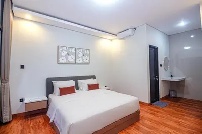 a bedroom with a large white bed in a room at The Hunian in Seminyak