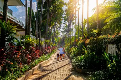 a man and a child walking down a path in a garden at Montigo Resorts Seminyak in Seminyak