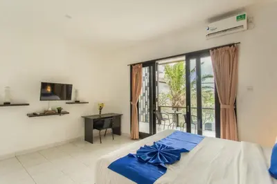 a bedroom with a bed and a large window at Taman Bali Villa Kerobokan 2 in Kerobokan