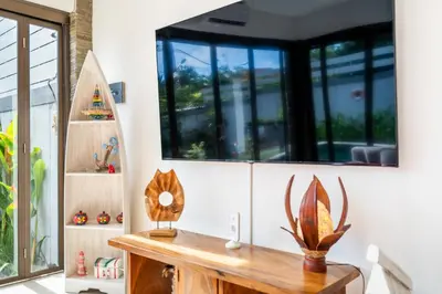 a room with a table with antlers on the wall at Villa Avaluna by JB Villas in Seminyak