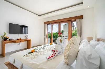 a bedroom with a bed with a swan decoration on it at Villa Avaluna by JB Villas in Seminyak
