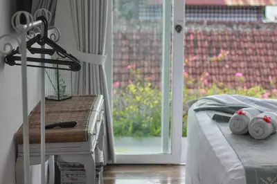 a bedroom with a bed and a sliding glass door at Villa Marabia - Charming Quiet 3BR in Seminyak in Seminyak