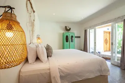 a bedroom with a large bed and a large window at New 5 bedroom Villa close to Seminyak eat street in Seminyak