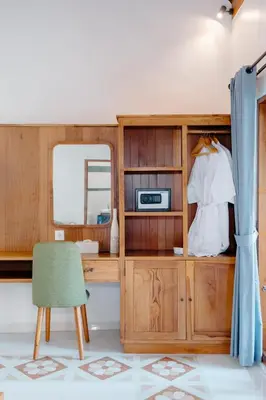 a desk with a mirror and a chair in a room at Kania Rooms & Suite in Seminyak