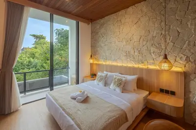a bedroom with a large bed with a large window at Vin Villa Kerobokan 2BR with Private Pool in Kerobokan